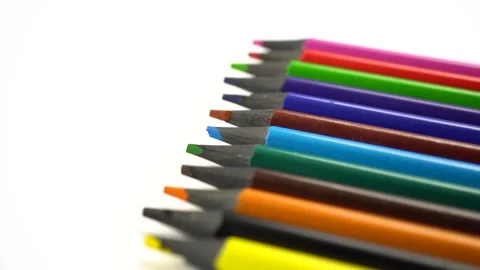 Slide shot of a set of colored sharpened pencils. Slow macro of a dollar on a Video stock 244334891