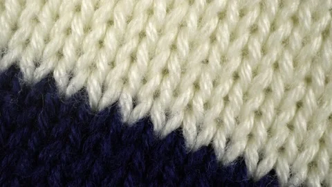 Slide shot of the texture of a knitted sweater. Slow motion macro of a knitte 動画素材 203827019