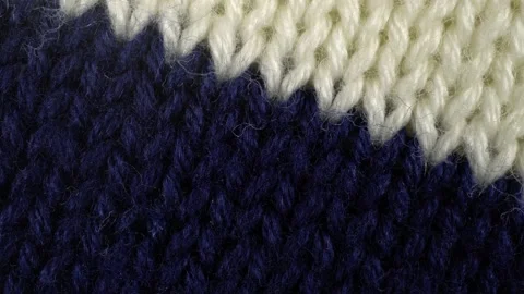 Slide shot of the texture of a knitted sweater. Slow motion macro of a knitte Stock Footage 219991342