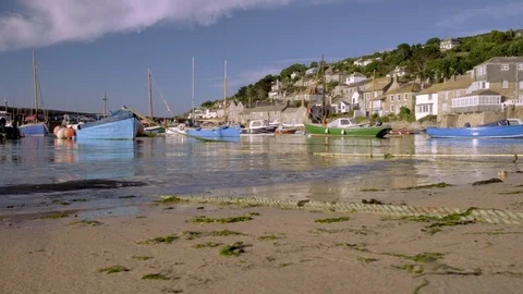 Slide shot as waves break in harbour of Mousehole Stock Footage 94941101