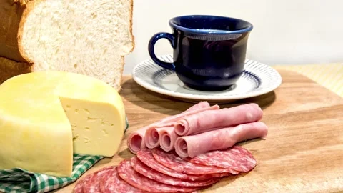 Slide show Colonial breakfast served with bread, cheese, ham and salami  Stock Footage 153636507