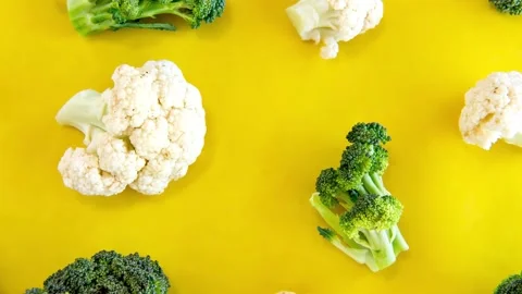 Slide show of Vegetables, broccoli and cauliflower on yellow background Stock Footage 165847648