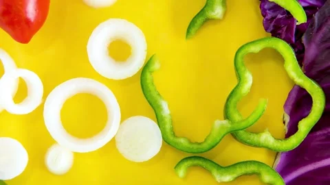 Slide show of Vegetables, cabbage, onion, tomato and peppers on yellow backg Stock Footage 165847720