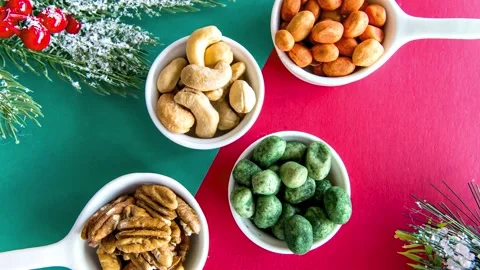 Slide show of Walnuts, peanuts and cashews on a Christmas table Stock Footage 165423794