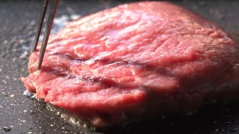 Slide slow motion shot of flip rib eye steak on grill pan 스톡 동영상 115777742