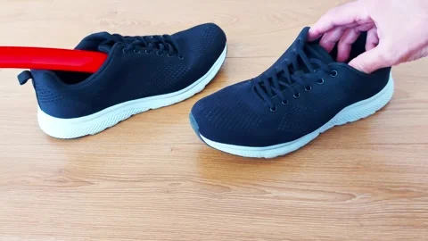Slide In Smoothly- Using a Shoe Horn to Wear Black Sneakers 스톡 동영상 312031894