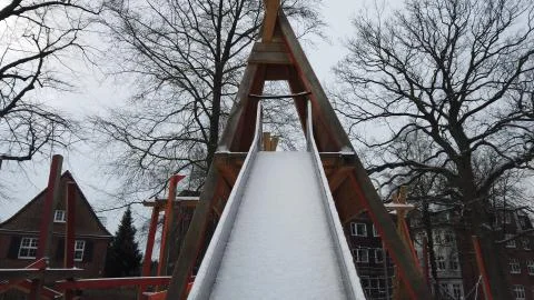 Slide in the Snow on a playground 库存照片