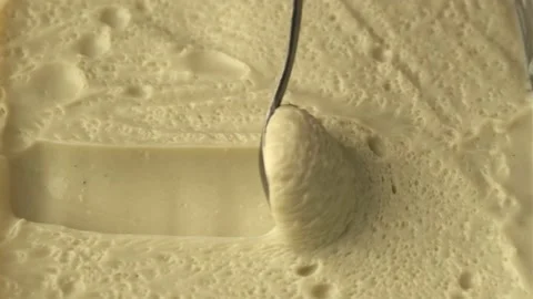 Slide of spoon to scoop up cream with bubbles. Stock Footage 218119141