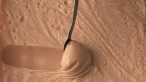 Slide of spoon to scoop up cream with bubbles. Stock Footage 219001595