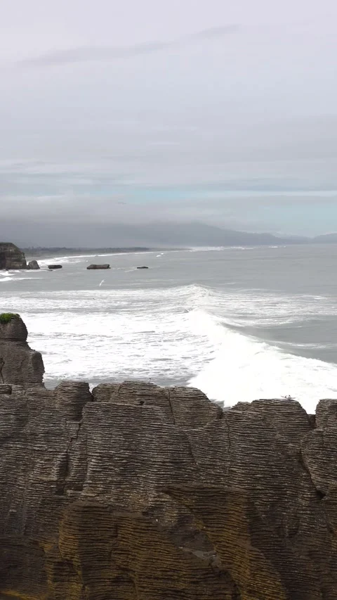 Slide transition by unique beach with eroded rock formations and water bird.. Stock Footage 289101750