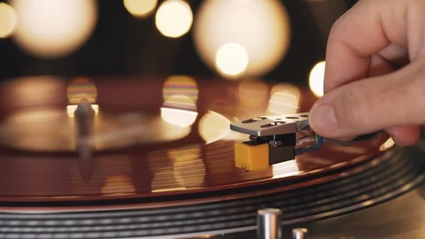 A slide turntable vinyl record player. Hand girl puts needle on red vinyl record Stock Footage 94449175