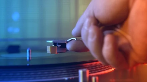 Slide vinyl record player turntable on a background of red and blue lights Stock Footage 91708139