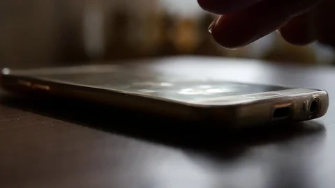 Slide your finger across the screen of your smartphone with a beautiful blur and Stock Footage 81630898