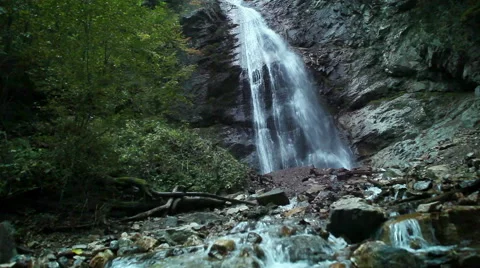 Slider camera in the mountain creek with waterfall background Video stock 54235939