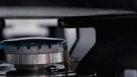 Slider close-up as the knob is turned to ignite the gas burner on the kitchen st Video stock 246470730