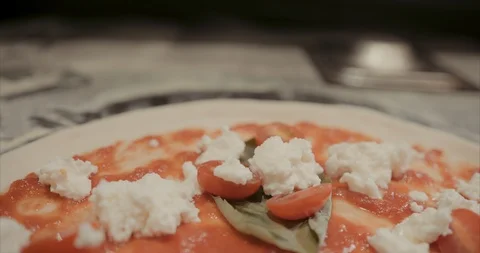 Slider hand held Fresh ingredients on a Neapolitan pizza after being prepped Stock Footage 105299983