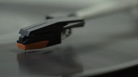 SLIDER FROM LEFT TO RIGHT OVER PLAYING VINYL TO TURNTABLE HEAD Stock Footage 126235913