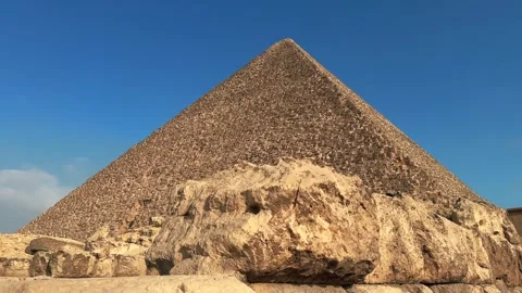 Slider Motion Shot of the Great Pyramid of Khufu with Large Rocky Ruins and 库存影片 341839119