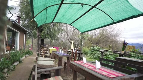Slider motion shot from left to right on outside dining room with some 스톡 동영상 283519813