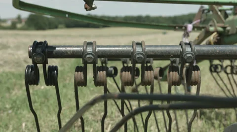 A slider move on a Field while a Tractor is driving in the Background in 4K Stock Footage 66453871