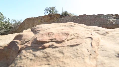 Slider over desert rocks, cave in BG Video stock 90072731