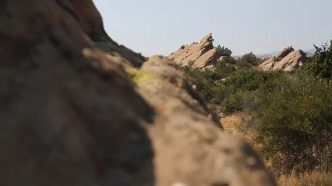 Slider over desert rocks, large outcrop in BG Video stock 90072562