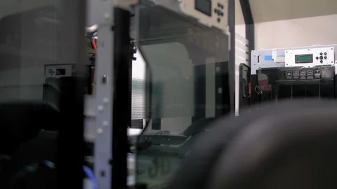Slider shot of a 3D printer on a desk in the office with a computer Stock-Footage 108965453