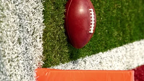 A slider shot along the sidelines to an American football at goal line. Stock Footage 218374212