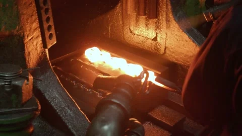 Slider Shot of American Worker Forging molten metal steel iron using Big Hammer Stock Footage