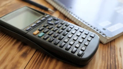A slider shot of calculator, notebook, coffee mug, and pencil Video stock 94015408
