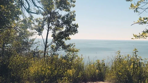 Slider shot from a cliff looking out at the lake and horizon. 4K UHD. Stock Footage 77327259