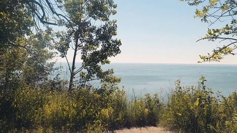 Slider shot from a cliff looking out at the lake and horizon. 4K UHD. Stock Footage 77327401