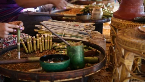 Slider shot of close up of local Burmese ladies rolling cigars Stock Footage 104122373