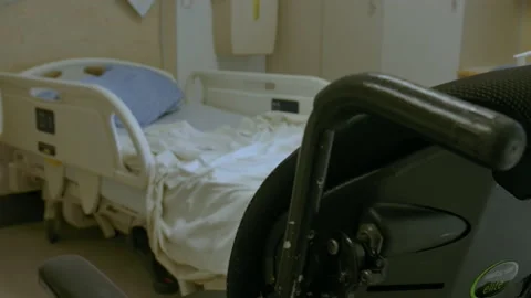 Slider shot of empty hospital bed and wheel chair Stock Footage 218630694