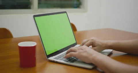Slider shot of freelancer working on laptop at home with green screen. Stock Footage 338439798