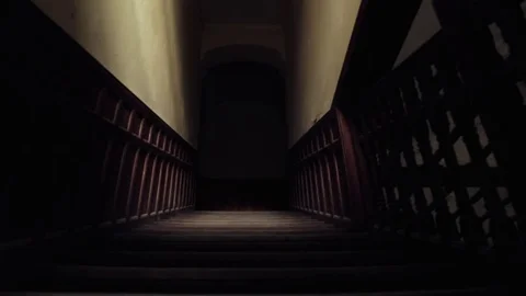 Slider shot going down staircase of old, empty, haunted building Stock Footage 81778296