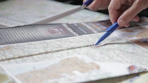 Slider shot hands tracing route on travel map Stock Footage 142736613