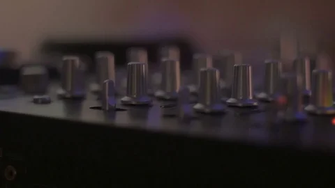 Slider shot of knobs of a DJ mixing board and colored meter lights moving 스톡 동영상 72081630