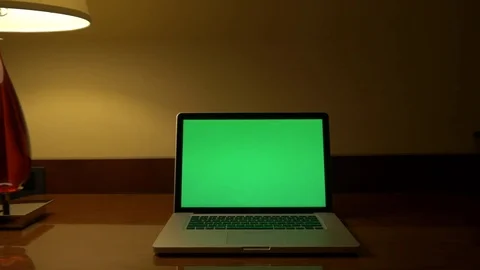 Slider Shot of a Laptop Computer with Green Screen on a Desk at Night. Stock Footage 82428121