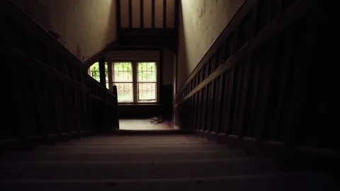 Slider shot looking down an old staircase of a haunted building, mansion. Stock Footage 81778353