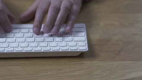 Slider shot: Man typing a computer keyboard and mouse Video stock 166358067