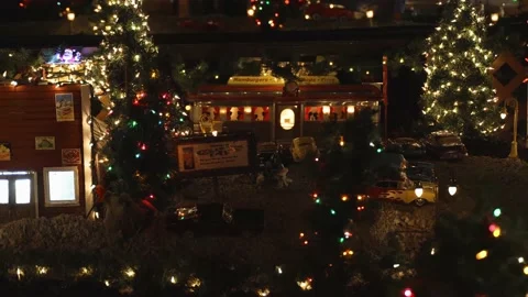 Slider shot of model train village at night revealing vintage diner Stock Footage 148796545