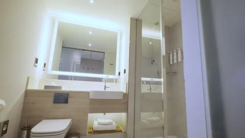 Slider shot of Modern Tiled Bathroom with Shower in modern real estate interior Vídeo Stock 257708709