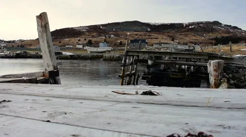 A slider shot of old docks with small boats located in Ferryland, NL. Stock Footage 61526453