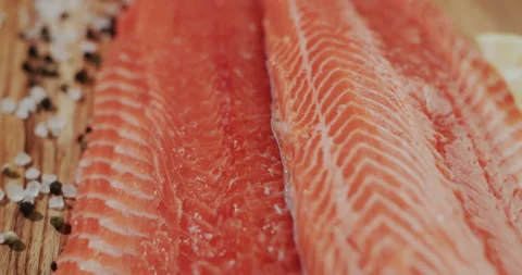 Slider shot: Salmon fillet on the table, next seasoning - pepper and salt. Stock Footage 149979515
