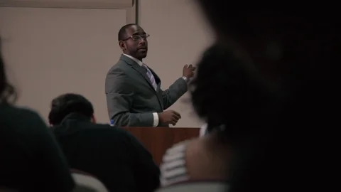 Slider shot of teacher from behind students in classroom Stock Footage