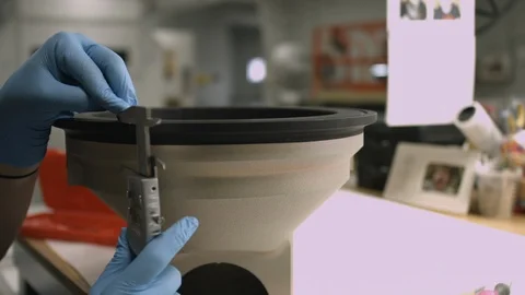Slider shot of a technician's hands using a caliper to measure thickness Stock Footage 115699731