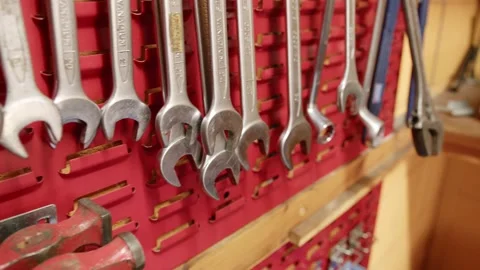 Slider shot of tools arranged on a wall mount inside an engineering Stock Footage 238510969