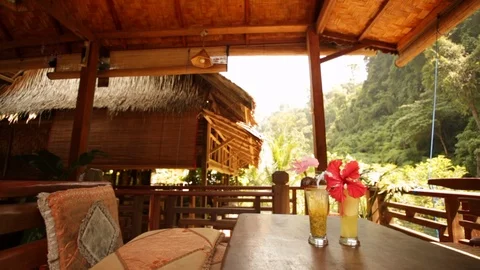 Slider shot of two fruit cocktail drinks on outdoor balcony in luxury resort Stock-Footage 107633871