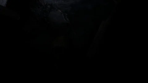 Slider towards flashlight reveal of corpse in crypt mouth open Stock Footage 95963058